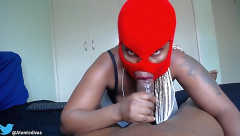 Ebony bitch with a tattoo on her face enjoys a blowjob
